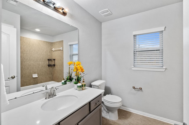 full bathroom with vanity, toilet, tile patterned floors, and plenty of natural light