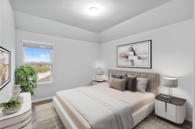 carpeted bedroom featuring a textured ceiling