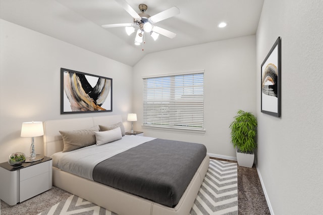 bedroom with ceiling fan, vaulted ceiling, and carpet floors