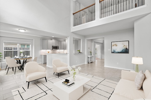 tiled living room with a towering ceiling