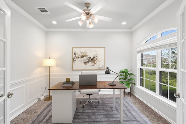 carpeted home office featuring crown molding and ceiling fan