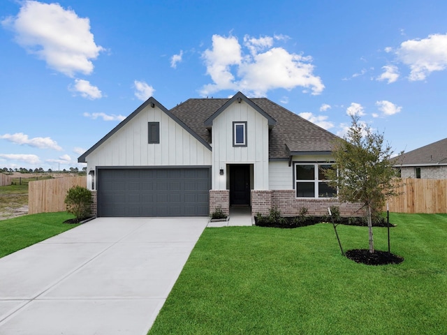 view of front of property with a front lawn and a garage