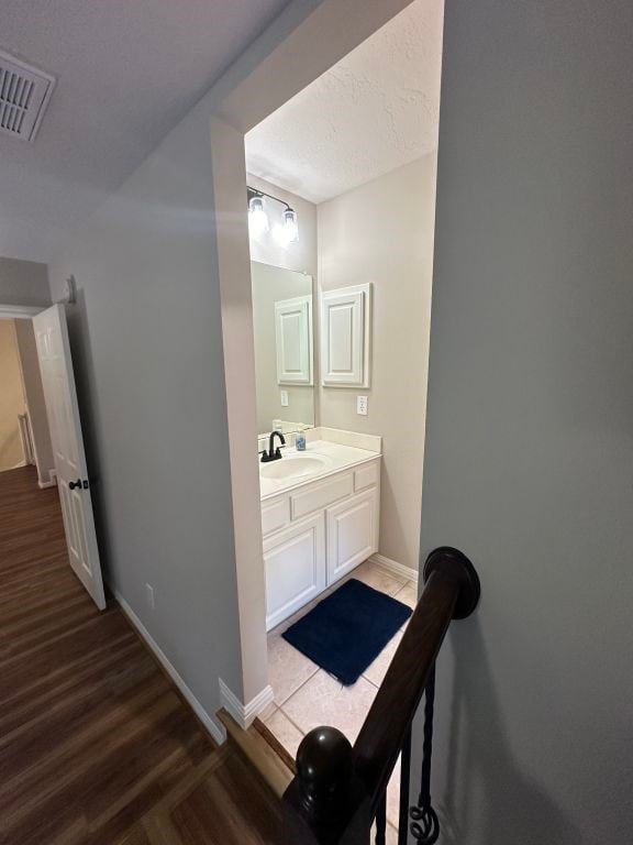 bathroom featuring vanity and hardwood / wood-style floors