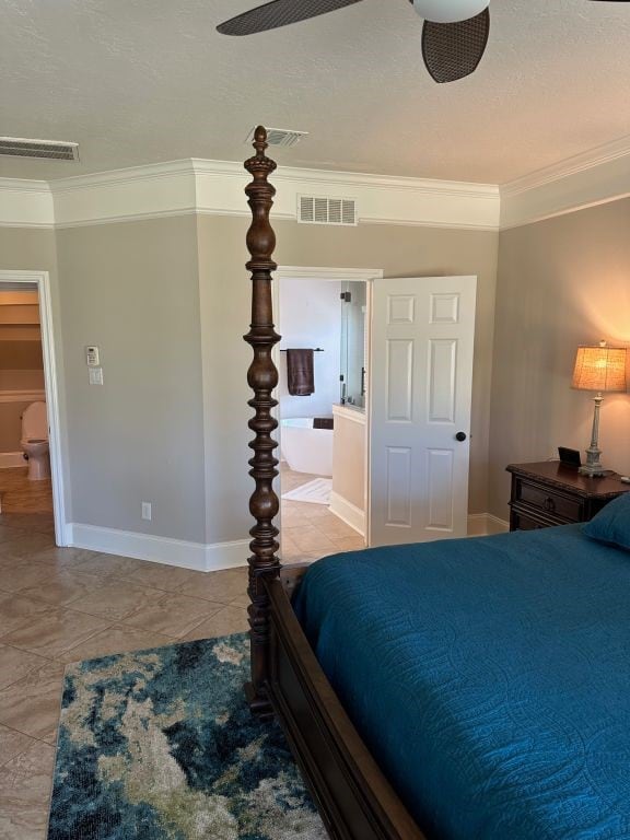 tiled bedroom with ensuite bath, ornamental molding, and ceiling fan