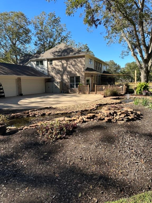 back of house with a wooden deck