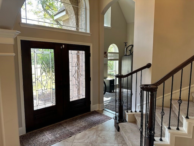 entryway featuring french doors and a high ceiling