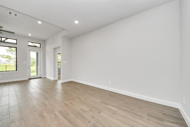 spare room with recessed lighting, baseboards, visible vents, and light wood-style floors