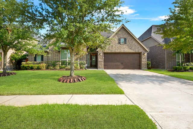 view of front of home with a front yard and a garage