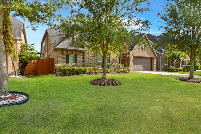 view of front of property with a front yard and a garage