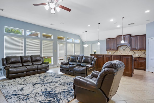 tiled living room featuring vaulted ceiling and ceiling fan