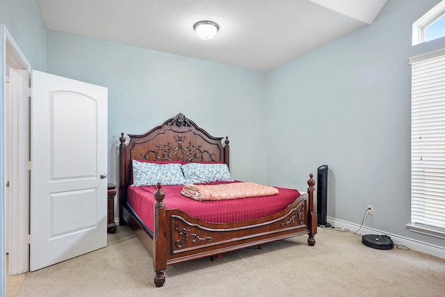 bedroom featuring light carpet