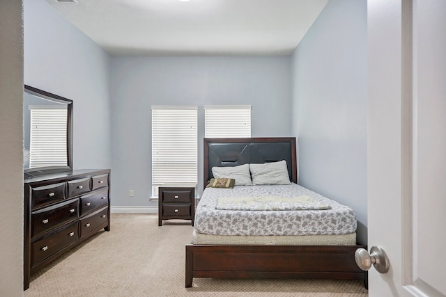 bedroom featuring light colored carpet