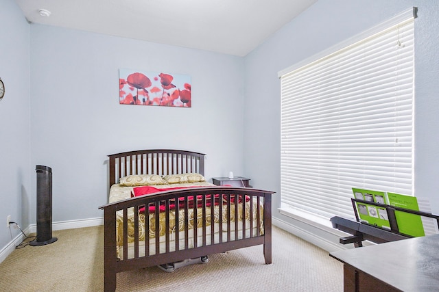 bedroom featuring multiple windows and carpet flooring