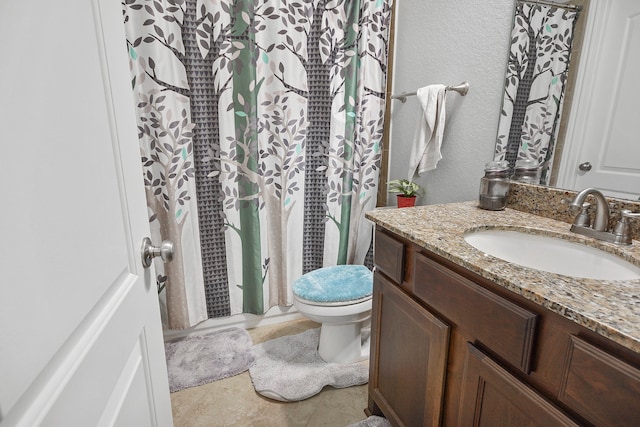 bathroom featuring vanity, a shower with curtain, toilet, and tile patterned flooring