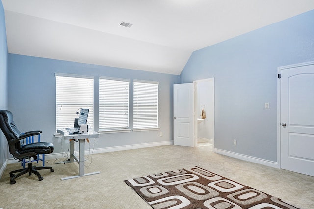 office featuring light carpet, a healthy amount of sunlight, and vaulted ceiling