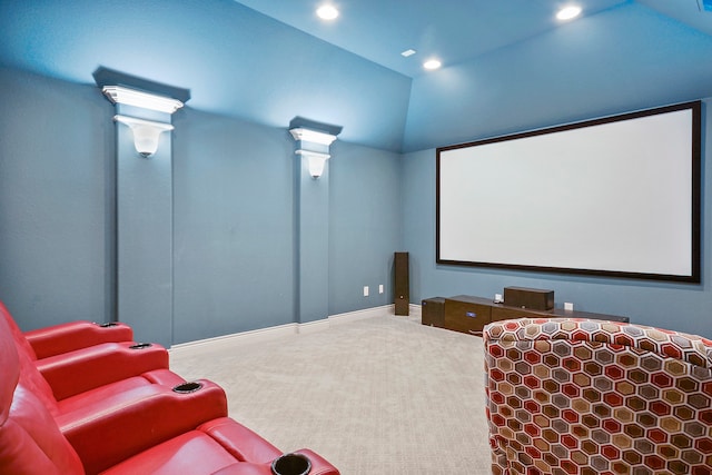 home theater room with carpet and vaulted ceiling