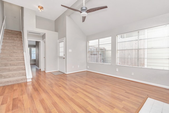 unfurnished living room with ceiling fan, high vaulted ceiling, and light hardwood / wood-style flooring