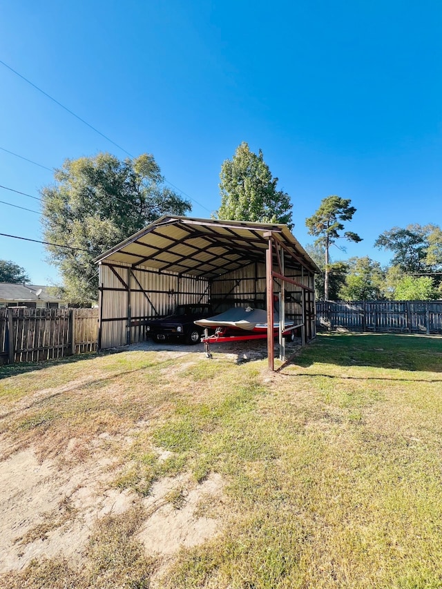 view of parking with a yard and a carport