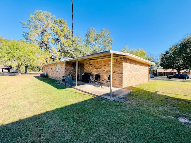 rear view of property with a yard and a patio