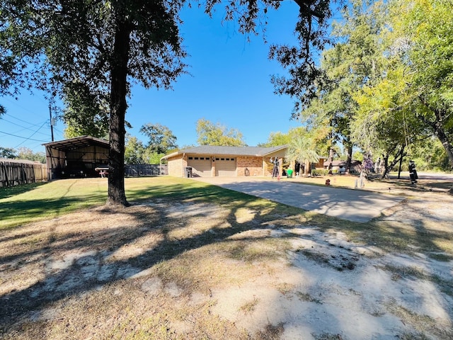 view of front of house with a carport, a garage, and a front lawn