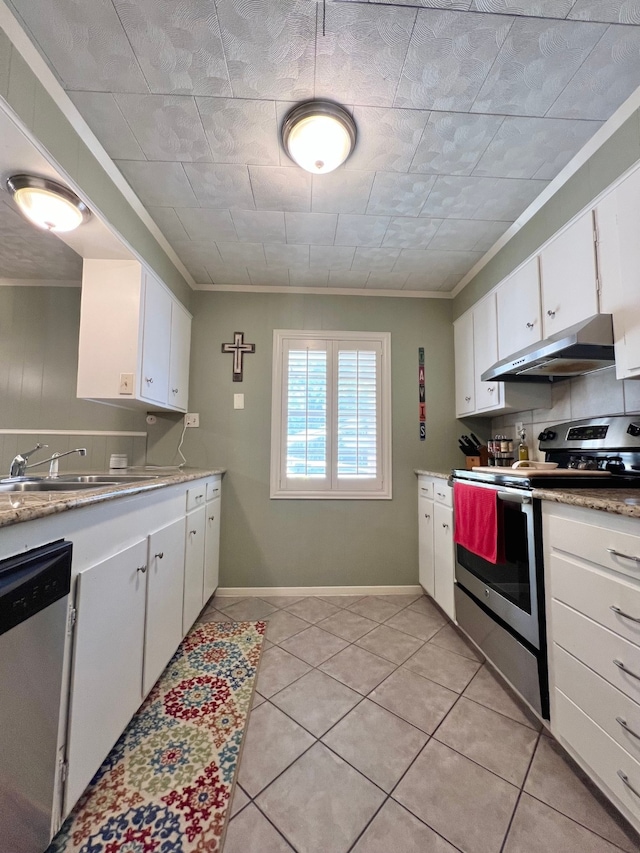 kitchen featuring white cabinets, appliances with stainless steel finishes, and light tile patterned flooring