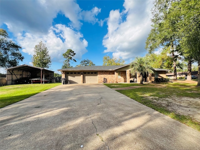 ranch-style house featuring a front yard, a garage, and a carport