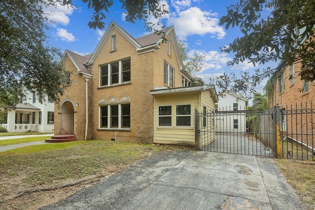 2409 Arbor St, Houston, TX 77004 - view of front of house with a gate, brick siding, and fence