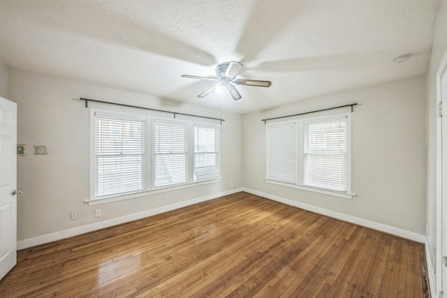 2409 Arbor St, Houston, TX 77004 - spare room featuring a ceiling fan, baseboards, wood finished floors, a textured ceiling, and a smoke detector
