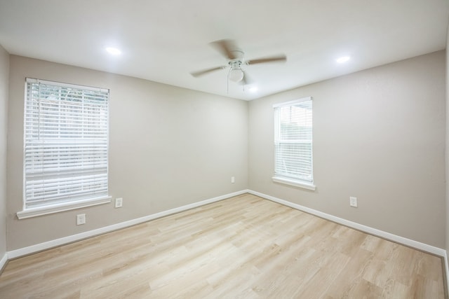 spare room with ceiling fan and light wood-type flooring