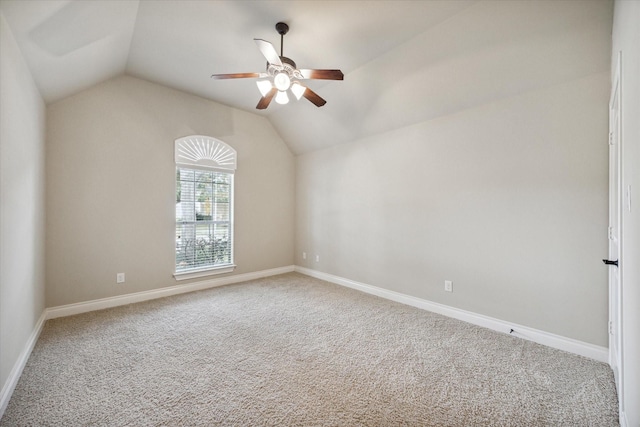 empty room featuring ceiling fan, carpet, and lofted ceiling