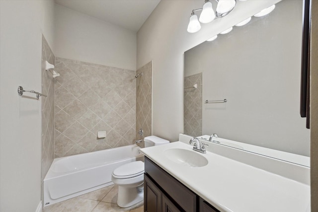 full bathroom with tile patterned flooring, tiled shower / bath combo, toilet, and vanity