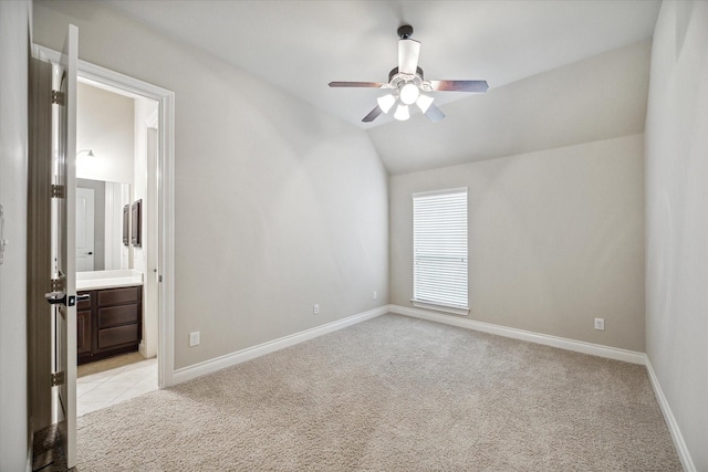 interior space with ceiling fan, light colored carpet, and lofted ceiling