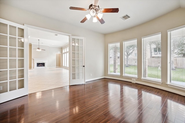 unfurnished room featuring hardwood / wood-style flooring, ceiling fan, and french doors