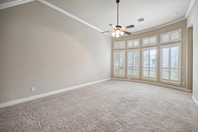 carpeted spare room with ceiling fan, ornamental molding, and vaulted ceiling