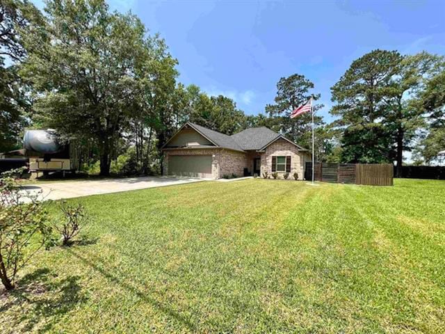 ranch-style home with a front lawn and a garage