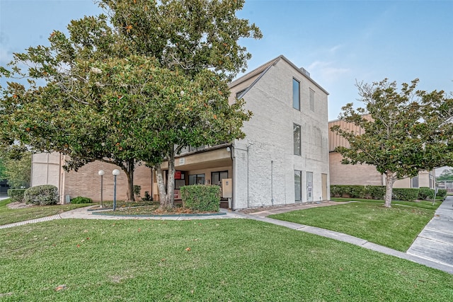 view of front of property with a front lawn and a balcony