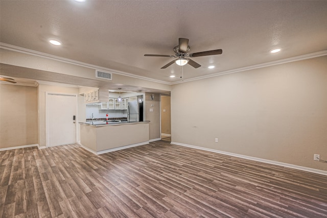 unfurnished living room with dark hardwood / wood-style flooring, a textured ceiling, ceiling fan, and crown molding