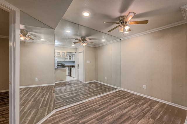 unfurnished living room with dark hardwood / wood-style floors, crown molding, and ceiling fan