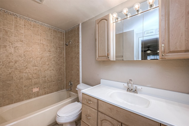 full bathroom featuring vanity, toilet, and tiled shower / bath