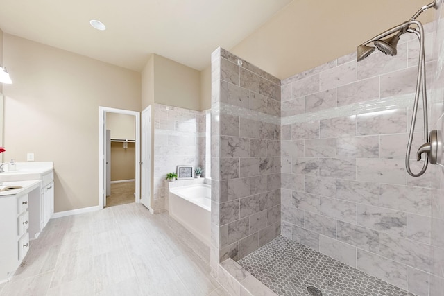 bathroom featuring vanity and plus walk in shower