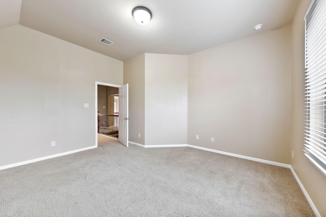 unfurnished bedroom with light carpet and vaulted ceiling