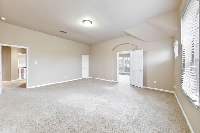 carpeted spare room featuring a healthy amount of sunlight