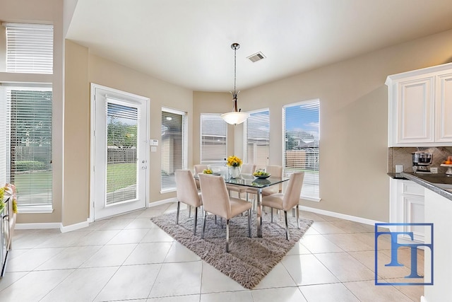 dining room featuring plenty of natural light and light tile patterned flooring