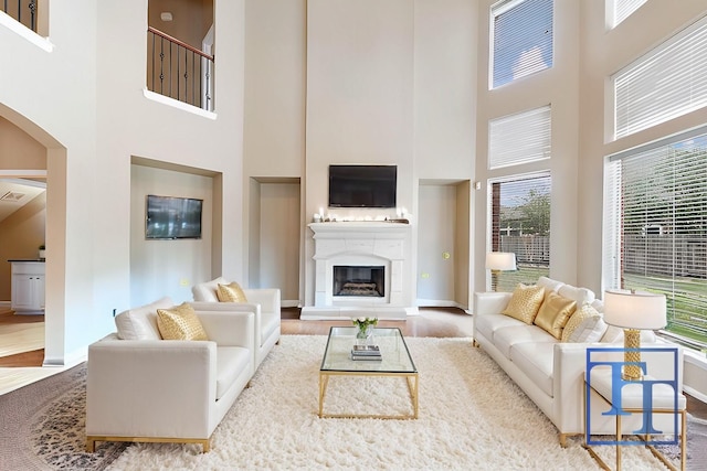 living room featuring wood-type flooring and a high ceiling