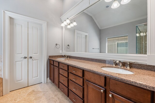 bathroom featuring vanity, vaulted ceiling, and ornamental molding