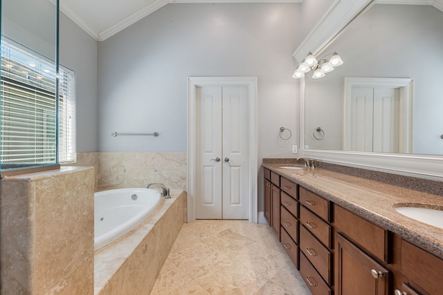 bathroom with vanity, crown molding, and tiled tub