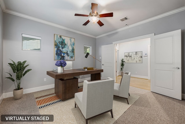 carpeted home office featuring ceiling fan and ornamental molding