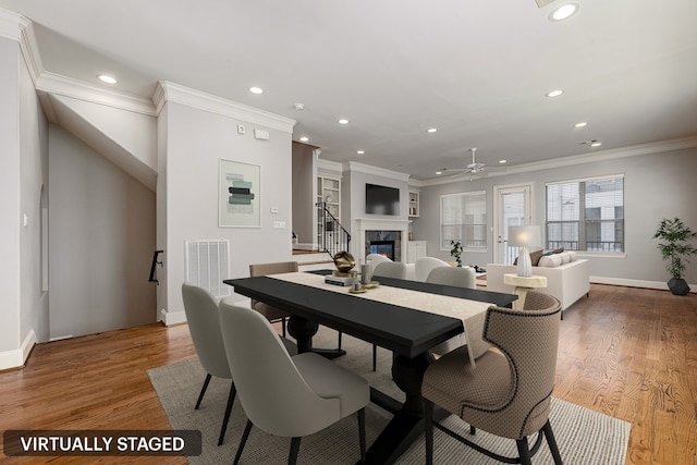 dining area featuring ceiling fan, wood-type flooring, and ornamental molding