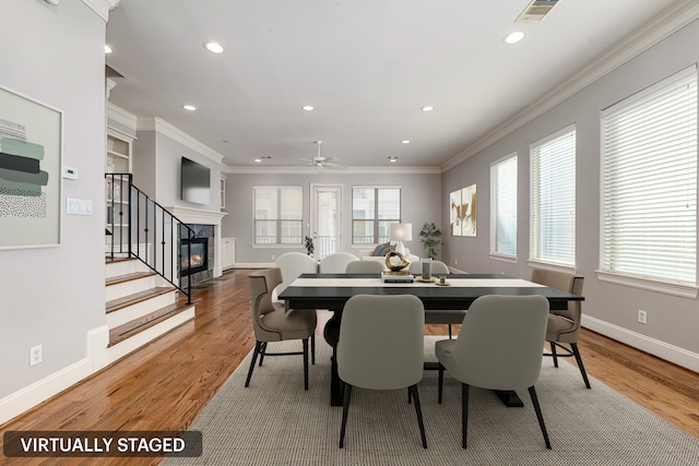 dining room with ceiling fan, wood-type flooring, and ornamental molding