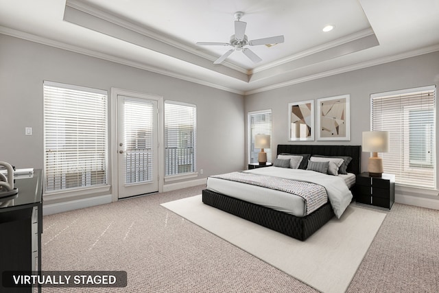 carpeted bedroom with access to exterior, a tray ceiling, ceiling fan, and crown molding